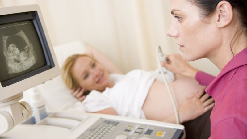 Ärztin macht Ultraschalluntersuchung bei schwangerer Frau