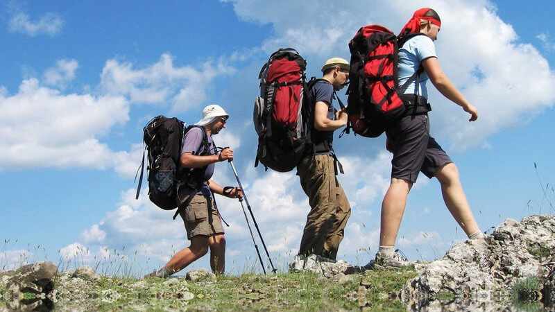 Drei Männer mit Rucksack beim Wandern