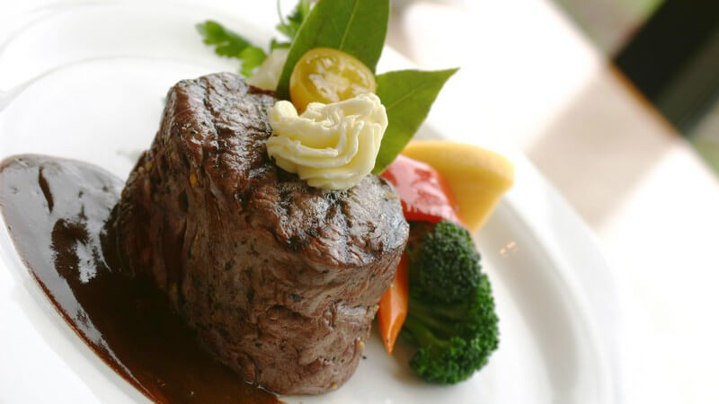 Steak mit Soße und Gemüse auf Teller