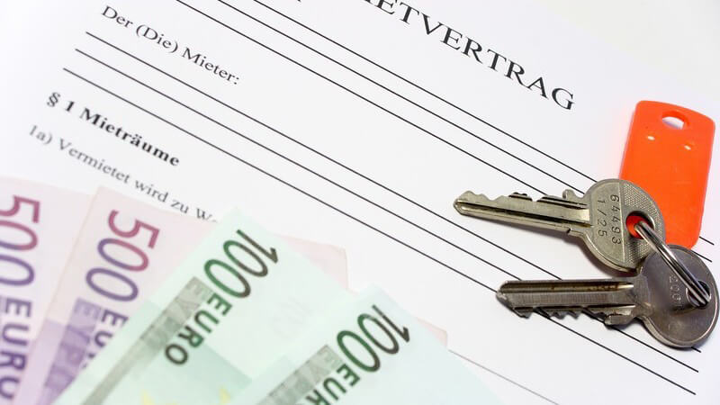 Schlüsselbund und Geldscheine auf Mietvertrag