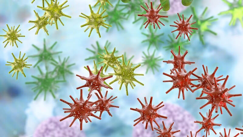 3-D-Grafik bunter Bakterien und Herpes zoster-Viren (Gürtelrose) vor blauem Hintergrund