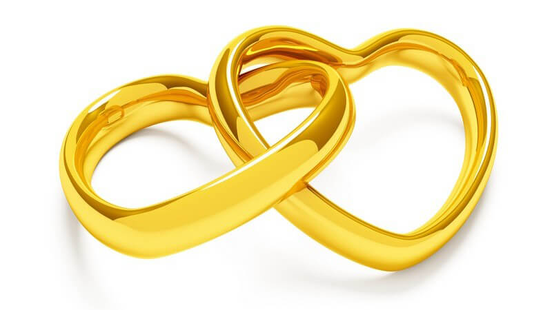 Grafik zwei goldene ineinander gelegte Ringe in Herzform