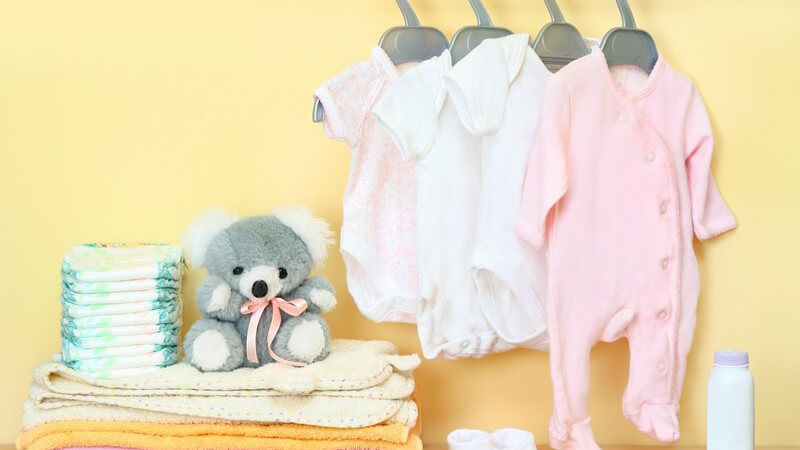 Regal mit Babyzubehör: Strampler, Windeln, Handtücher, Fläschchen