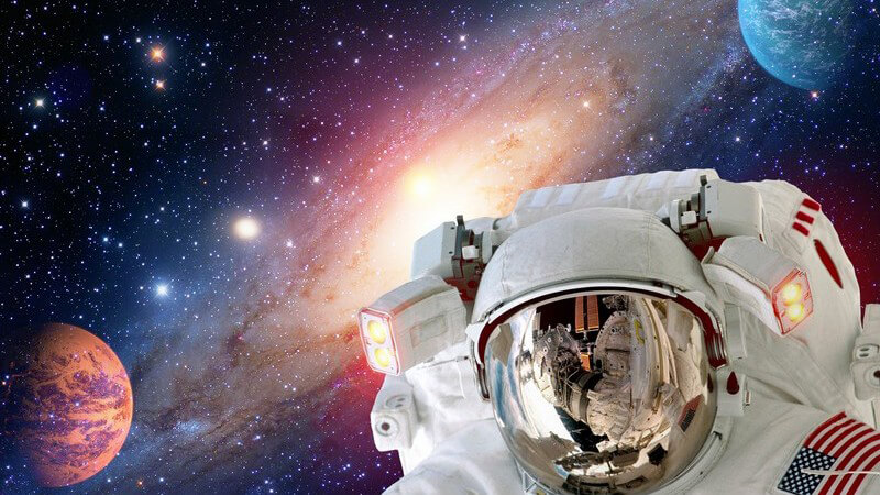 US-amerikanischer Astronaut schwebt im Weltall, die Milchstraße und zwei Planeten im Hintergrund